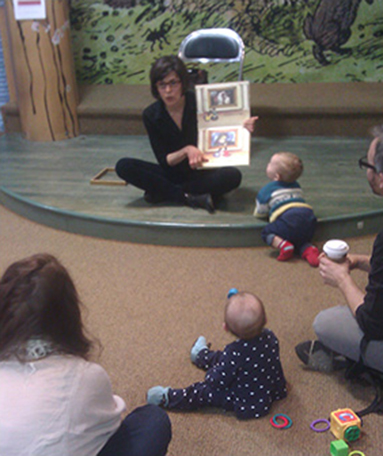 Image of Kimberly Marrero reading her book, The Art of You and Me - KM Art Advisory New York